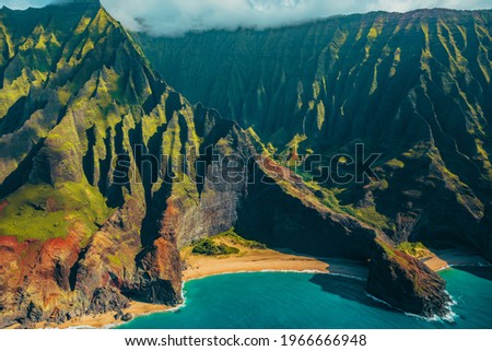 Hawaii Kauai Na Pali coast landscape aerial view from helicopter. Nature coastline dramatic mountains with secluded popular tourist attraction beach. USA destination.