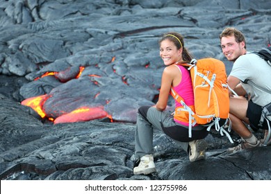 Hawaii Lava Tourist On Hike. Tourists Hiking Near Flowing Lava From Kilauea Volcano Around Hawaii Volcanoes National Park, USA. Multiethnic Couple.