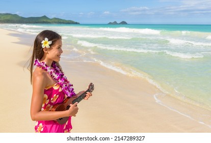 Hawaii Luau Ukulele Hula Dancing Woman Playing Ukulele Guitar On Beach Vacation Travel Wearing Flower Lei Necklace And Paero. Multiracial Asian Dancer Smiling On Hawaiian Travel Vacation