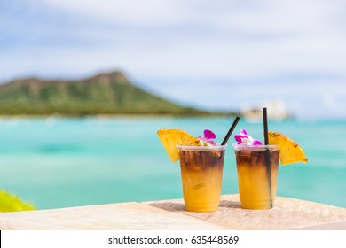 Hawaii Mai Tai Drinks On Waikiki Beach Bar Travel Vacation In Honolulu, Hawaii. Famous Hawaiian Drink Cocktails With View Of Ocean And Diamond Head Mountain, Hawaii Tourist Attraction.