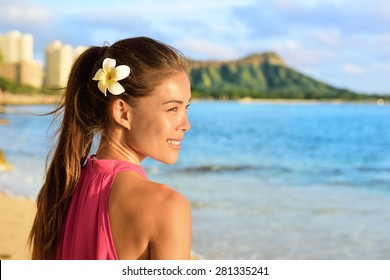 Hawaiian beach woman on Waikiki - beautiful biracial Asian Caucasian girl brunette relaxing and enjoying sun. Oahu, Hawaii, USA. - Powered by Shutterstock