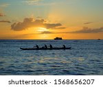 Hawaiian outrigger canoe with paddlers 