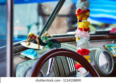 Hawaiian pink, red, blue orange, Lei in a vintage Woody Car with Surfers and Sunglasses at a fun car show.