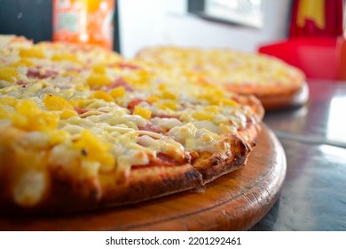 Hawaiian Pizza On A Wooden Base