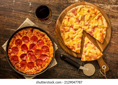 Hawaiian pizza and Pepperoni pizza on wood table - Shutterstock ID 2129047787