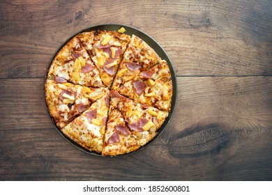 Hawaiian Pizza Shot From Above On A Wooden Table