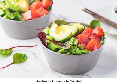 Hawaiian Poke - Brown Rice, Salmon, Edamame, Cucumber And Avocado In A Gray Bowl, Marble Background. Fish Fresh Salad For A Healthy Diet.