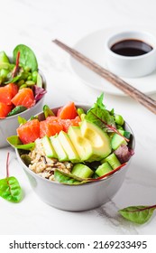 Hawaiian Poke - Brown Rice, Salmon, Edamame, Cucumber And Avocado In A Gray Bowl, Marble Background. Fish Fresh Salad For A Healthy Diet.