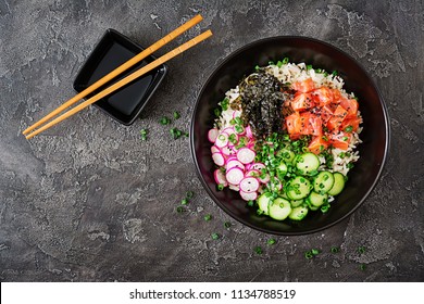 Hawaiian Salmon Fish Poke Bowl With Rice, Radish,cucumber, Tomato, Sesame Seeds And Seaweeds. Buddha Bowl. Diet Food. Top View. Flat Lay