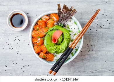 Hawaiian Salmon Poke Bowl With Seaweed, Avocado Rose, Sesame Seeds And Scallions. Top View, Overhead, Flat Lay