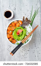 Hawaiian Salmon Poke Bowl With Seaweed, Avocado Rose, Sesame Seeds And Scallions. Top View, Overhead, Flat Lay