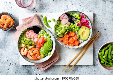 Hawaiian Salmon And Shrimp Poke Bowl With Seaweed, Avocado, Watermelon Radish, Edamame And Cucumber. Top View, Overhead