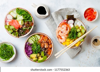 Hawaiian salmon, tuna and shrimp poke bowls with seaweed, avocado, mango, pickled ginger, sesame seeds. Top view, overhead, flat lay