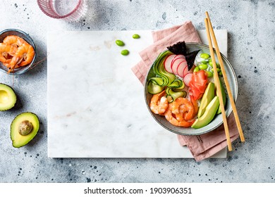 Hawaiian Shrimp Poke Bowl With Seaweed, Avocado, Watermelon Radish, Edamame And Cucumber. Top View, Overhead