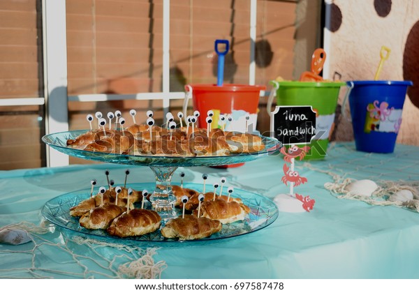 hawaiian-tiki-bar-themed-birthday-party-stock-photo-697587478