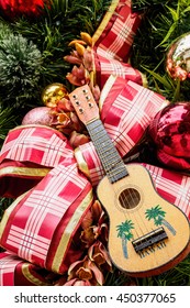 Hawaiian Ukulele And Large Ribbon On Christmas Tree.