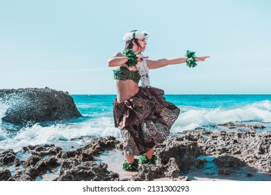 Hawaiian woman enjoys hula dancing on the beach barefoot wearing traditional costume - Powered by Shutterstock