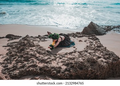 Hawaiian Woman Smiles Relaxed On A Paradise Beach. Exotic Beauty With Flower Crown On Her Head.