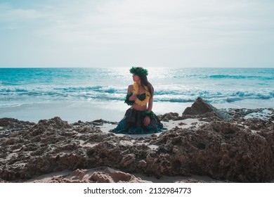 Hawaiian Woman Smiles Relaxed On A Paradise Beach. Exotic Beauty With Flower Crown On Her Head.