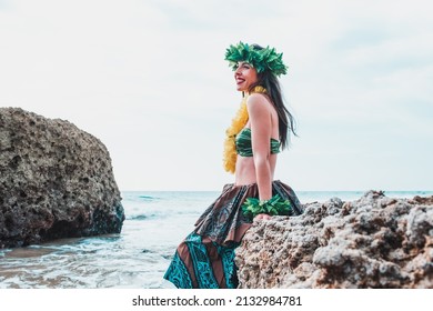 Hawaiian Woman Smiles Relaxed On A Paradise Beach. Exotic Beauty With Flower Crown On Her Head.