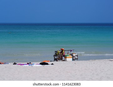 Hawker On Beach Of Island, Merchant Carry And Sell Food To Tourism On Beach ,Thai Street Vendor Selling Traditional Food On Beach CHAWENG  BEACH SAMUI ISLAND THAILAND