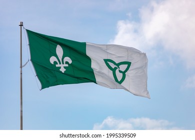 HAWKESBURY, ONTARIO, CANADA - JUNE 21, 2021: The Franco-Ontarian Flag, Representing French Canadian Heritage In Parts Of Ontario, Flies On A Flagpole At Ile Du Chenail.