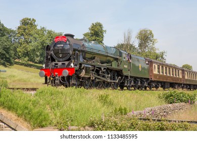 HAWORTH, ENGLAND, JUNE 26 2018 Former London Midland and Scottish Railway steam locomotive 46100 Royal Scot leaving Haworth on The Keighley and Worth Valley Railway, England.