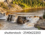 The Hay River cascades over layers of sedimentary rocks at Louise Falls