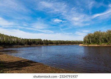 Hay River flowing quietly, Northwest Territories, Canada - Shutterstock ID 2324791937