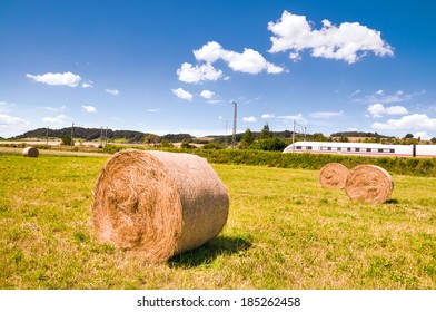 Hay Rolls On The Field And A Passing Bullet Train