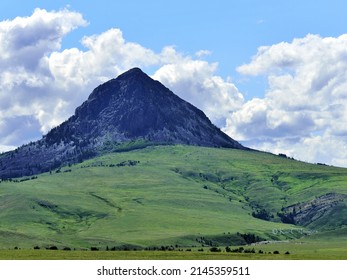 Haystack Butte, geological feature in western Montana and background for several sections of grazing land. Cattle are small marks in foreground.