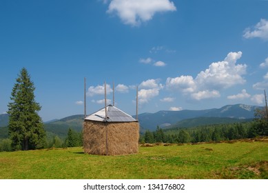 haystack on a green field