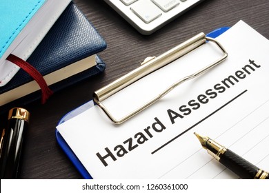Hazard Assessment Form With Clipboard On A Desk.