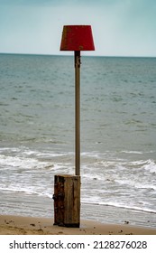 Hazard Sign On Beach At Low Tide