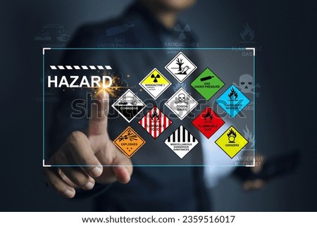 Hazardous substance concept engineer pointing on hazard icon dangerous goods store in warehouse create warning sign for different chemical separate storage area for cargo shipping and transportation.