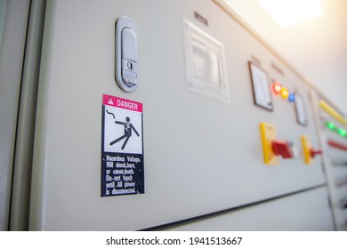 Hazardous Voltage Sign In Main Distribution Board Of Electric Plant. Warning Sign On Electric Control Cabinet Of Electrical Room. 