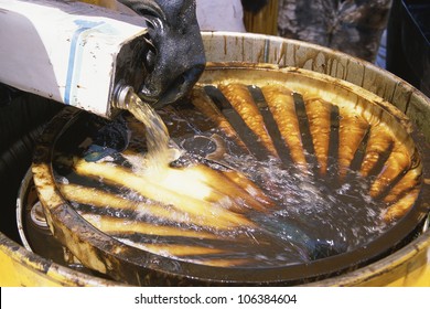 Hazardous Waste Being Poured Into Steel Container