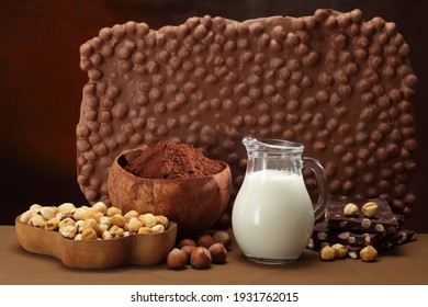 Hazelnut Chocolate , Milk Jug, Cocoa Powder And Hazelnuts In A Bowl