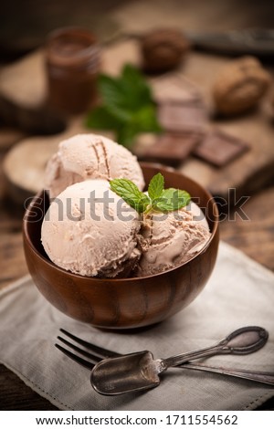 Hazelnut Icecream in  a bowl on wooden table. Close up