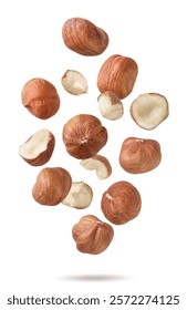 Hazelnuts, halves and pieces flying close-up on a white background. Isolated