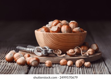 Hazelnuts and nut cracker on rustic wooden table. Food photography - Powered by Shutterstock