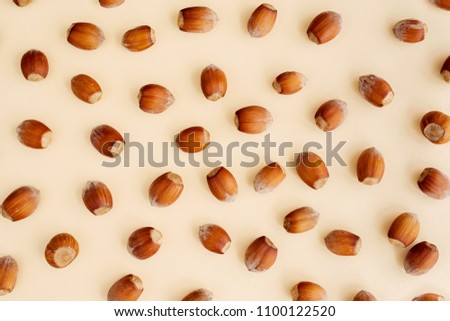Hazelnuts on yellow background, flatlay