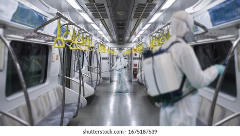 HazMat team in protective suits decontaminating metro car during virus outbreak. Coronavirus COVID-19