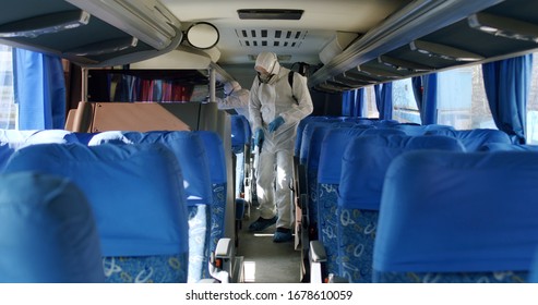 HazMat team in protective suits decontaminating public transport tourist bus interior during virus outbreak - Shutterstock ID 1678610059