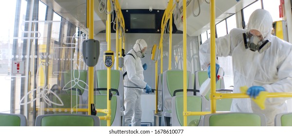 HazMat team in protective suits decontaminating public transport, bus interior during virus outbreak