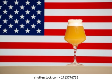 A Hazy Craft Beer In A Teku Glass With A American Flag Background.