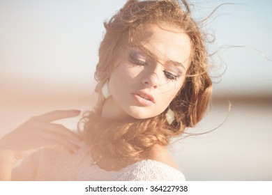 Hazy Portrait Of A Beautiful Young Woman With Curly Hair