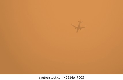 hazy sky with airplane flying in smoke condition, brooklyn, new york city (haze, smoky, smog from wildfires in nova scotia, canada) pollution from fire, yellow sky