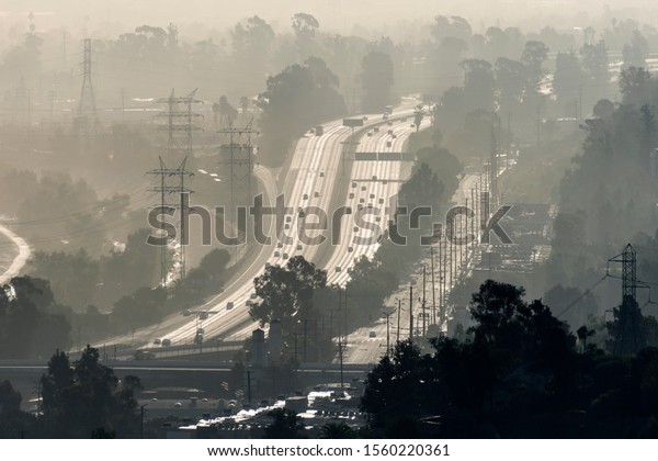 Hazy\
smoggy view of the 5 freeway near Riverside Drive, Griffith Park\
and the Los Angeles River in Southern California. \
