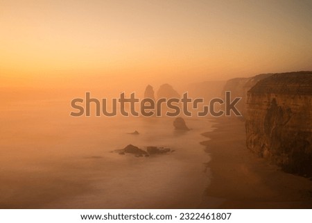 Hazy sunset over the Twelve Apostles on the Great Ocean Road, Victoria, Australia. Conditions were so foggy that you could not see the apostles in the distance.